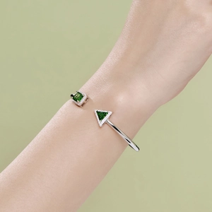 Detail of S925 silver spring bangle with square and triangle green ice cut zircon