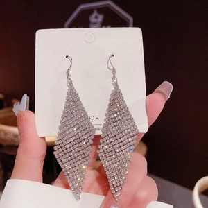 Detailed shot of long tassel earrings with S925 silver needles and sparkling crystals