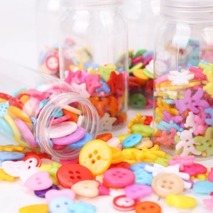 Macro shot of colorful plastic DIY buttons in various shapes spilled from a glass bottle