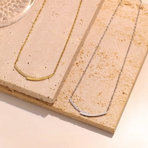 Minimalist smile arc necklace with micro-pave zircons in gold and silver finishes