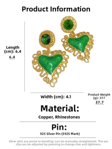 Detail view of vintage heart earrings with green enamel and rhinestones 6.4x4.1cm