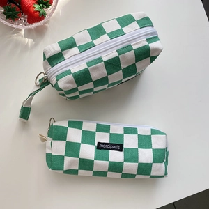 Detail of green and white checkerboard canvas stationery bags with metal zipper pulls