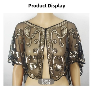 Detail of vintage black mesh shawl with gold sequin paisley patterns and embroidery