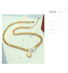 Detail of 18k gold plated chunky chain necklace with freshwater pearl pendant accents