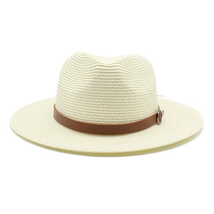 Detail of Panama straw hat featuring cream woven texture and brown leather strap buckle