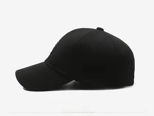 Side view of black baseball cap showing textured honeycomb fabric and embossed side logo