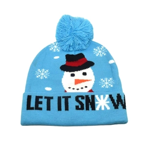 Close-up of blue winter knit hat featuring a snowman pattern and Let It Snow text