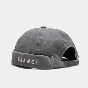 Detail of washed grey cotton brimless cap with white CHANCE embroidery and buckle