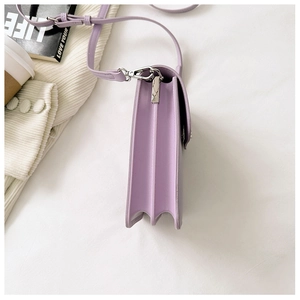 Detail of purple leather mini phone bag showing three-layer side accordion structure