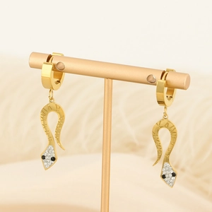Detailed view of snake earrings with roman numerals and rhinestones on a display stand