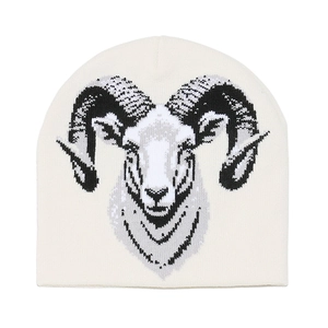 Detailed view of stylized ram head jacquard pattern on cream knitted beanie hat