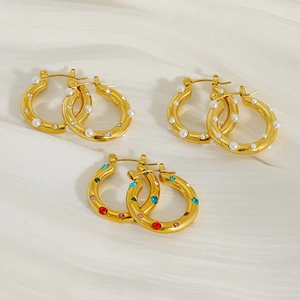 Close-up of three pairs of 18K gold-plated hoop earrings with pearls and colorful zircons