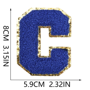 Macro detail of blue chenille letter C patch with gold glitter edge showing 8cm height