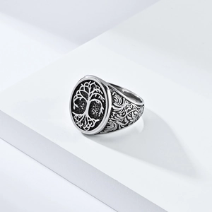 Vintage silver tree of life signet ring with floral engraving on white display