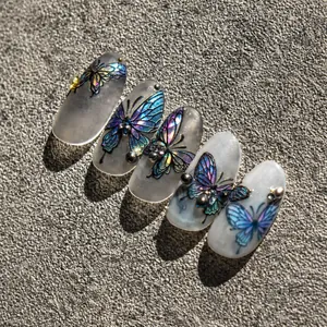 Detail of laser butterfly nail stickers with blue-purple gradient on translucent white tips