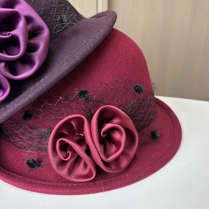 Detail of vintage wool felt hats with satin rose flowers and polka dot mesh veils