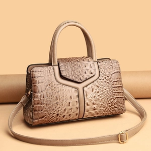 Beige crocodile texture tote bag with gold hardware and adjustable shoulder strap