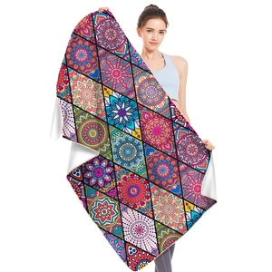 Microfiber beach towel with colorful bohemian mandala pattern shown by a model
