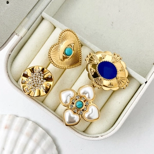 Vintage gold ring set with turquoise heart and blue gemstones in a jewelry box