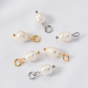 Close-up of natural freshwater pearl charms with gold and silver jewelry connectors
