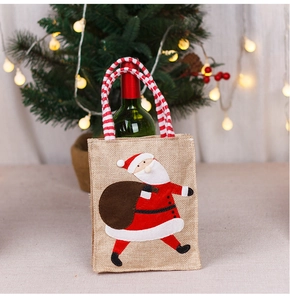 Linen Christmas wine gift bag featuring a Santa Claus patch and striped knit handle