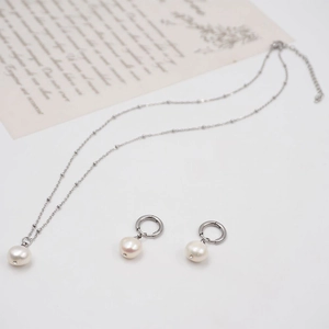 Elegant silver pearl necklace and hoop earring set with freshwater pearl on white background