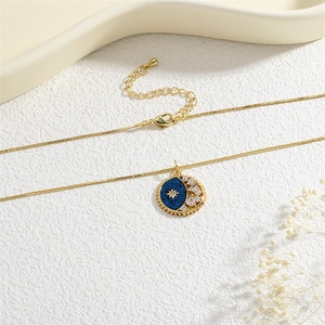 Detail of star and moon pendant with deep blue glitter and sparkling cubic zirconia stones