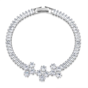 Detail of luxury silver bracelet with clear baguette zircons and floral cluster clasp