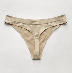 Detail of seamless nude thong with elastic microfiber texture and clean finished edges