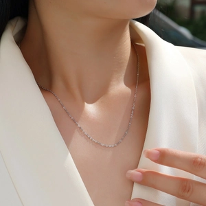 Minimalist 925 sterling silver chain necklace worn with a white blazer for a stylish look