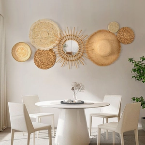 Detailed texture of bohemian handmade straw woven wall baskets and rattan mirror set