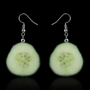 Detailed close-up of realistic cucumber slice earrings with textured seeds and green skin