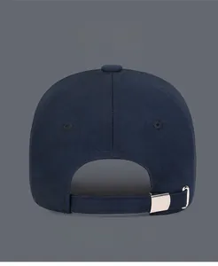 Detail of adjustable metal buckle and breathable eyelets on a navy baseball cap