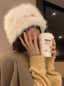 Close-up of a thick white faux fur plush bucket hat with fluffy texture for winter