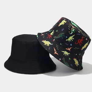 Detail of reversible bucket hat showing cute colorful dinosaur patterns and black canvas fabric