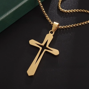 Macro view of gold hollow-out geometric cross pendant with classic metal box chain