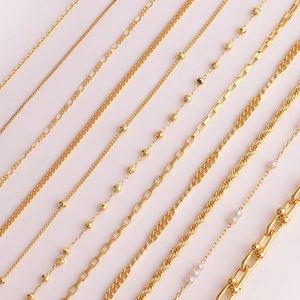 Close-up of various gold-plated copper chain styles including O-chains and box chains