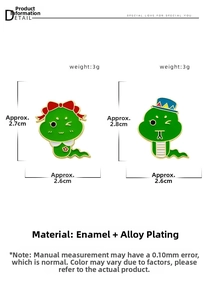 Detail of green enamel snake brooches showing cartoon style and alloy plating texture