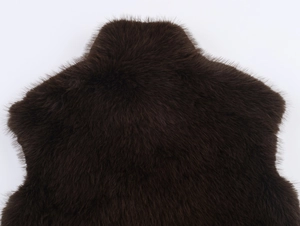 Detailed view of deep brown faux fur texture with long plush fibers and natural sheen