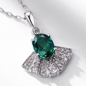 S925 silver fan-shaped necklace featuring oval emerald gemstone and white zircon accents