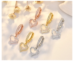 Detailed view of three-tone luxury heart hoop earrings with micro-set cubic zirconia stones