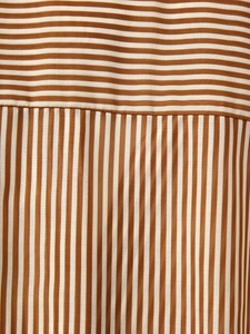 Detailed macro view of the brown and white striped tencel fabric texture and stitching
