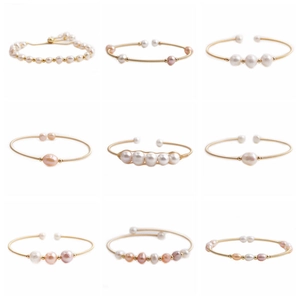 Detail showcase of pearl bracelets with white, pink, and purple pearls on gold metal bands