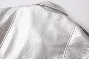 Detail of silver faux leather jacket showing metallic finish on collar and shoulder seams