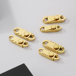 Detailed close-up of golden stainless steel Miami Cuban link jewelry clasps and buckles