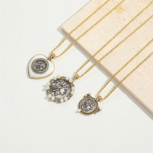 Vintage gold necklaces with coin pendants and pearl details on minimalist stone