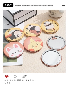 Macro shot of cartoon animal foldable mirrors on a wooden surface with soft lighting