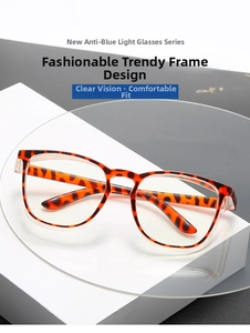 Detail of tortoise frame anti-blue light glasses with polished metal hinges on a white stand