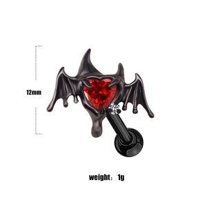 Macro view of gothic bat wing heart piercing with red gem and 12mm size marker