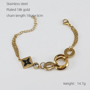 Detail of 18k gold plated titanium steel multi-layer chain bracelet with clover pendant